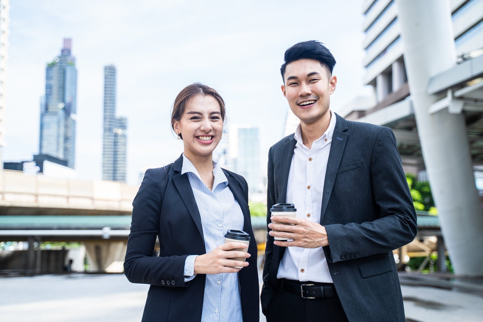 asian-businesswoman-and-man-stand-outdoor-in-city-2025-03-24-10-17-37-utc